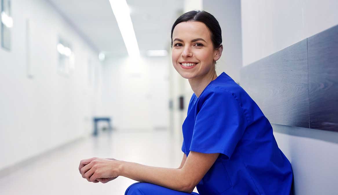 247 nursing & medical services, overseas nurse placements, nursing agency, young female nurse sitting in hospital